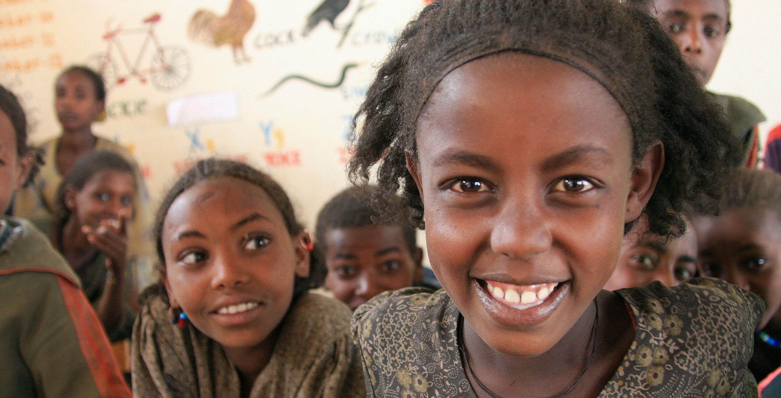 A group of Ethiopian school girls smiling in a classroom