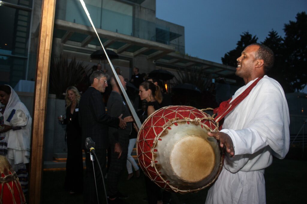 imagine1day Program Coordinator Halefom Gezaei plays a traditional Ethiopian drum song.