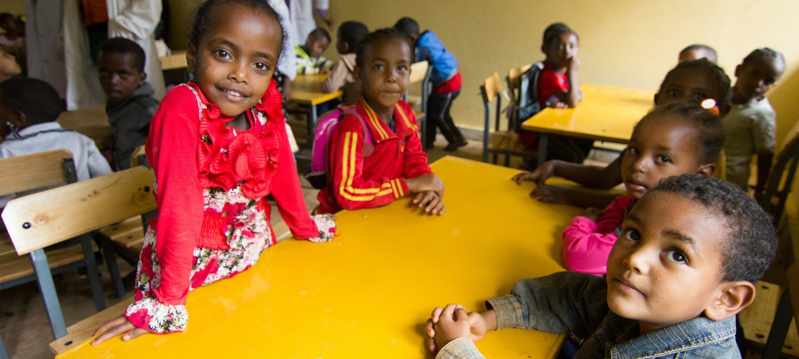 Young students sit at a desk in their new classrooms at Yadot Primary School.